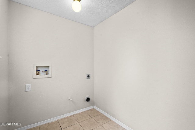 laundry room with light tile patterned floors, laundry area, a textured ceiling, washer hookup, and electric dryer hookup