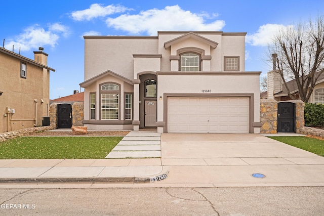 view of front facade with an attached garage, a gate, concrete driveway, and stucco siding