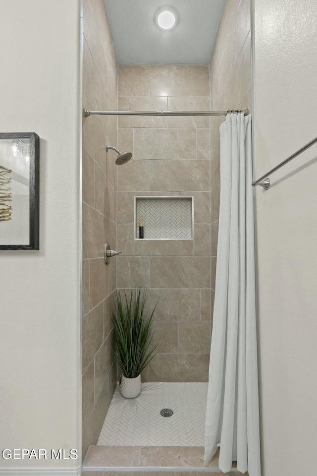 full bathroom featuring a shower stall