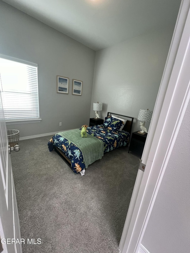 carpeted bedroom featuring baseboards