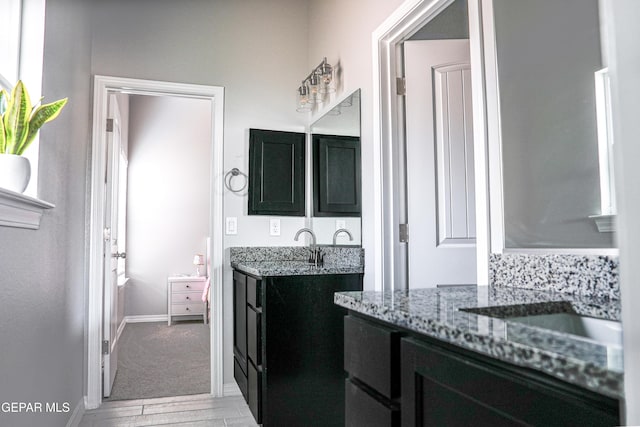 3853 Surmise St, El Paso, TX 79938 - full bathroom with two vanities and wood finished floors
