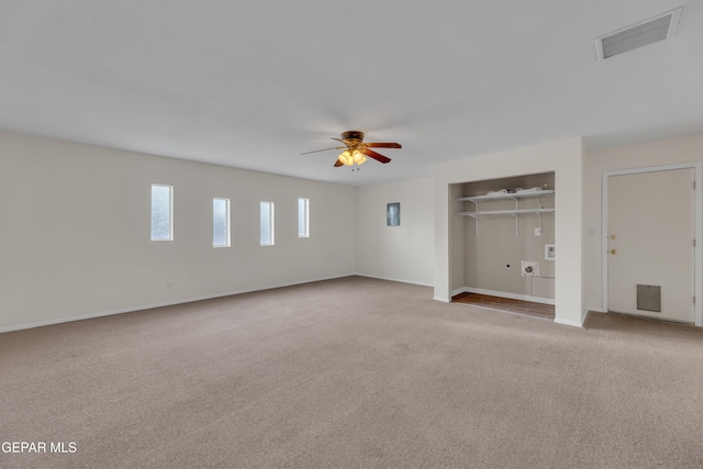 unfurnished bedroom featuring light carpet, visible vents, baseboards, a ceiling fan, and a closet