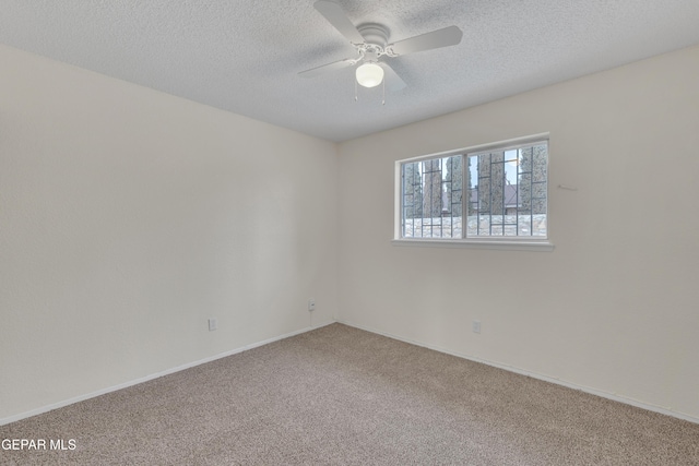 unfurnished room with a textured ceiling, ceiling fan, carpet flooring, and baseboards