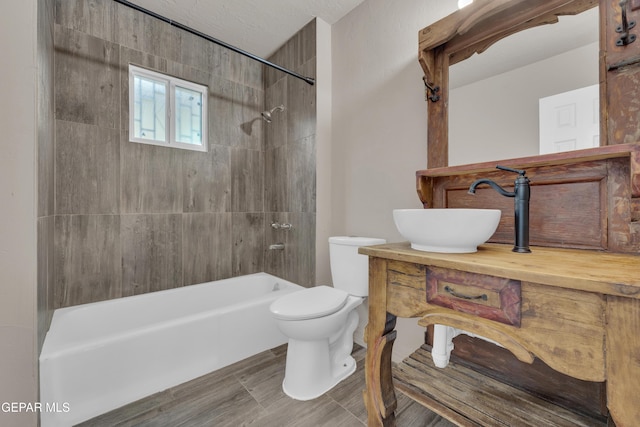 bathroom featuring toilet, tub / shower combination, and vanity