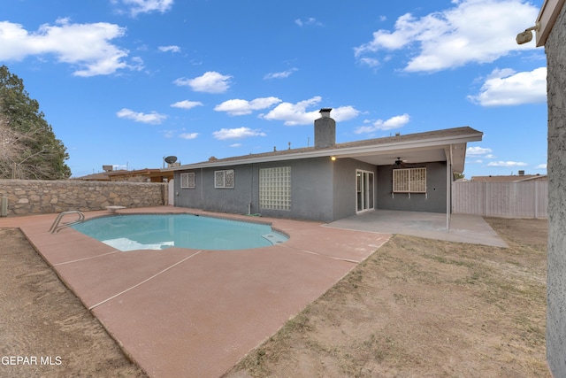 view of swimming pool with a patio, a fenced backyard, a ceiling fan, a diving board, and a fenced in pool