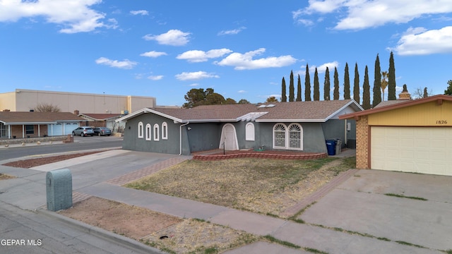 single story home featuring concrete driveway and stucco siding