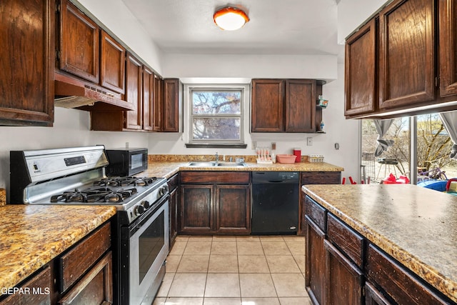 kitchen featuring light countertops, dark brown cabinetry, under cabinet range hood, and black appliances