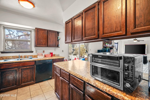 kitchen featuring light stone counters, a toaster, light tile patterned floors, a sink, and dishwasher