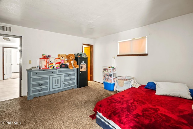 carpeted bedroom featuring visible vents