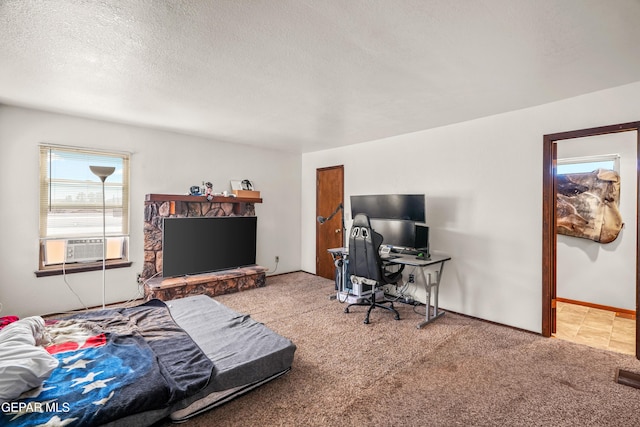 bedroom with baseboards, cooling unit, a textured ceiling, and light colored carpet