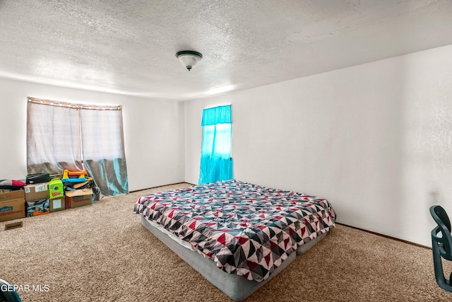 bedroom with carpet and a textured ceiling