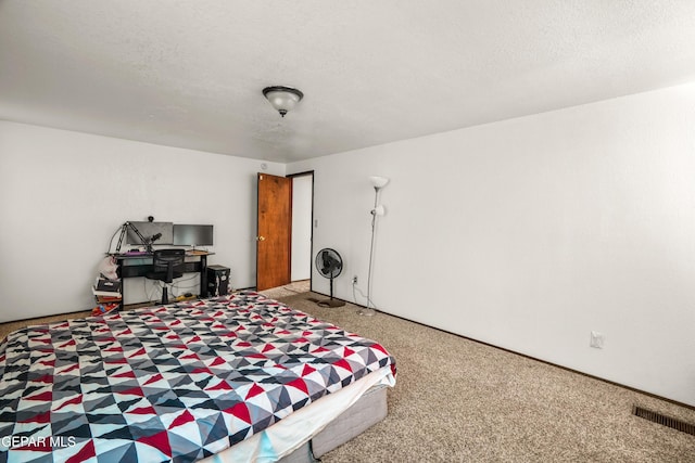 carpeted bedroom with visible vents and a textured ceiling