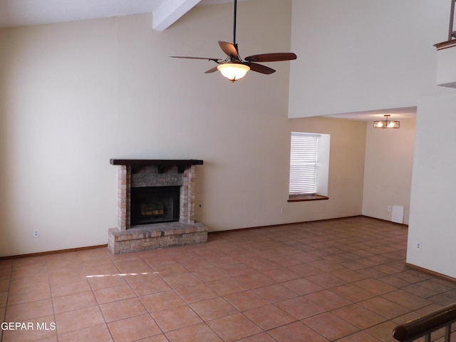 unfurnished living room with light tile patterned floors, a ceiling fan, baseboards, a brick fireplace, and beam ceiling