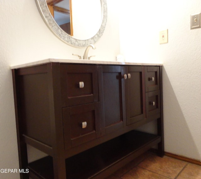 bathroom featuring vanity, baseboards, and tile patterned floors