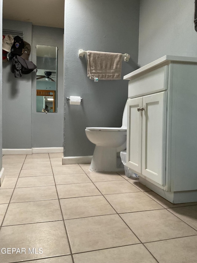 bathroom featuring toilet, baseboards, and tile patterned floors