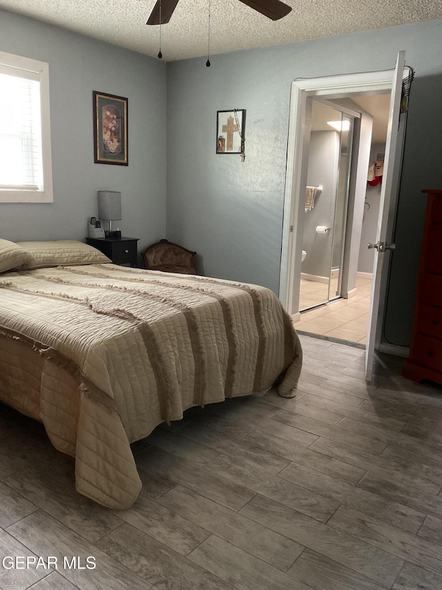 bedroom featuring light wood finished floors, ceiling fan, and a textured ceiling