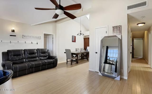 living room featuring visible vents, ceiling fan, baseboards, and wood finished floors