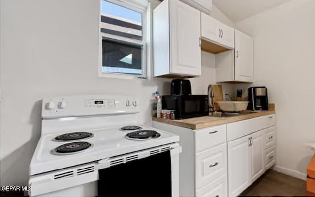 kitchen with white electric range oven, light countertops, white cabinetry, a sink, and baseboards