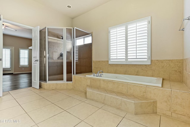 full bath with lofted ceiling, a garden tub, a shower stall, and tile patterned floors