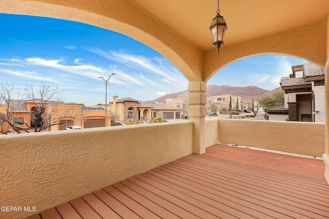 deck with a residential view and a mountain view