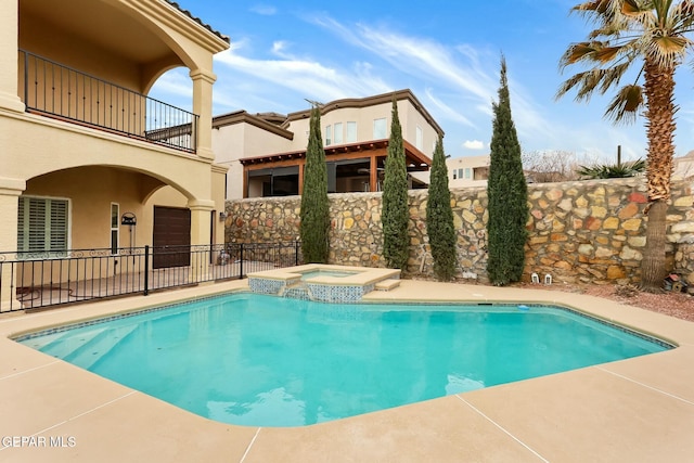 view of pool featuring a fenced in pool, fence, and an in ground hot tub