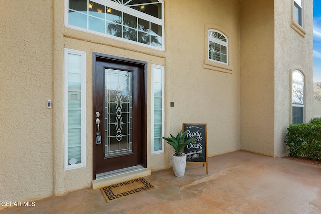 property entrance featuring stucco siding