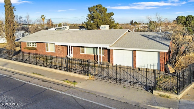 single story home with a garage, a fenced front yard, concrete driveway, and brick siding