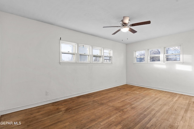 unfurnished room with light wood-style floors, ceiling fan, and baseboards