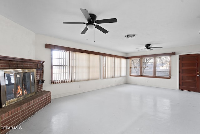 living area with a wealth of natural light, visible vents, and finished concrete floors