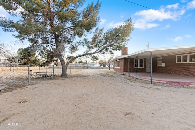 view of yard with fence and a patio