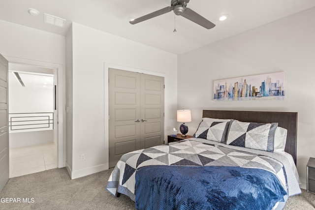 bedroom with light carpet, baseboards, visible vents, a ceiling fan, and a closet