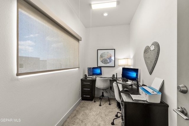 home office featuring baseboards and light colored carpet