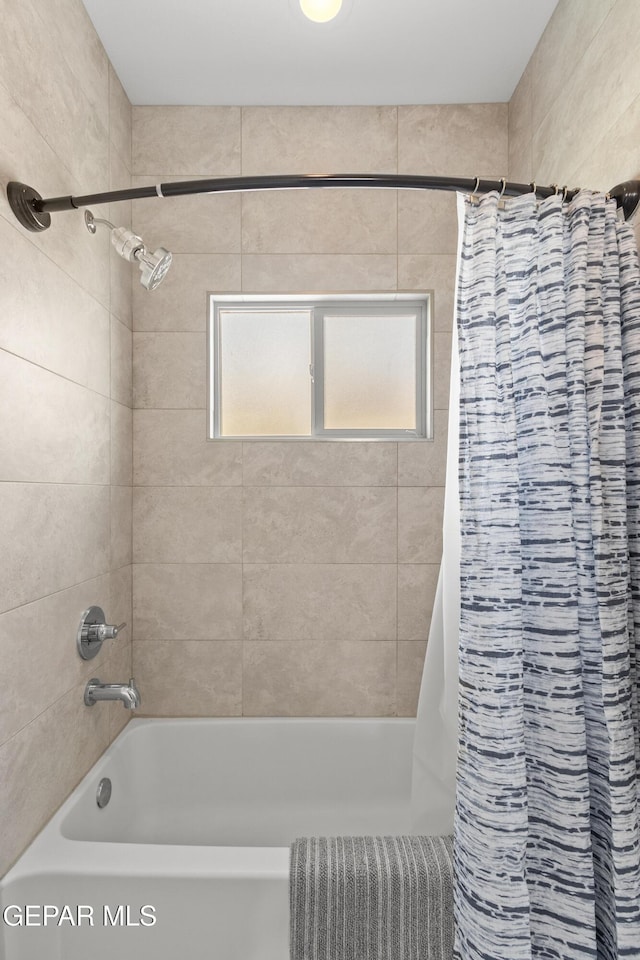 bathroom with shower / bath combination with curtain