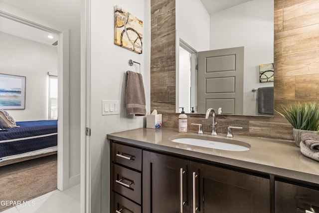 ensuite bathroom featuring connected bathroom and vanity