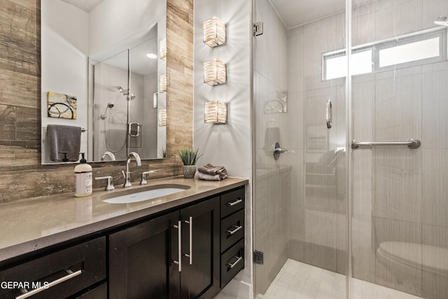 full bathroom featuring a stall shower and vanity