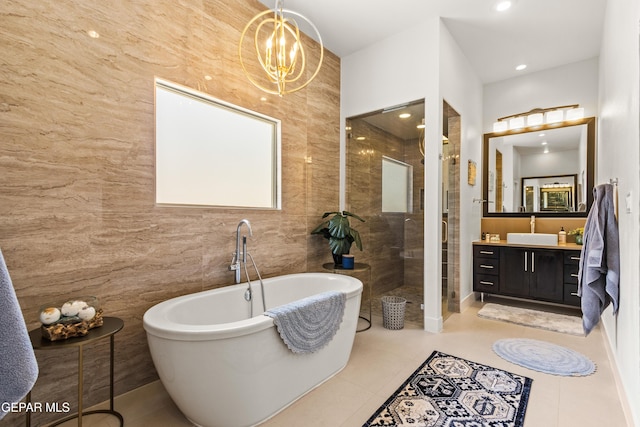 full bathroom featuring a soaking tub, a shower stall, tile walls, and tile patterned floors