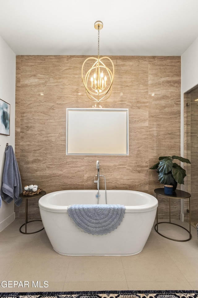 bathroom featuring a freestanding bath, tile walls, and tile patterned floors