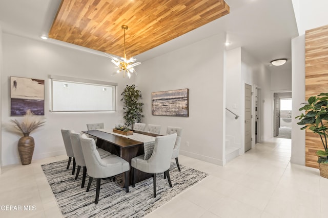 dining room featuring a notable chandelier, stairway, wood ceiling, light tile patterned flooring, and baseboards