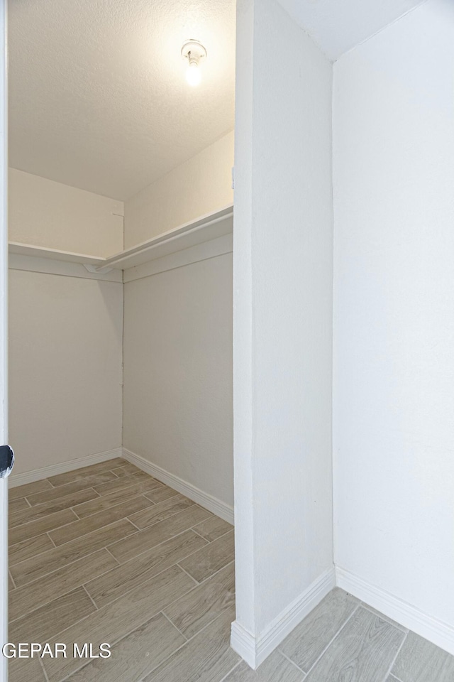 spacious closet with wood finish floors