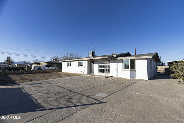 ranch-style home with concrete block siding