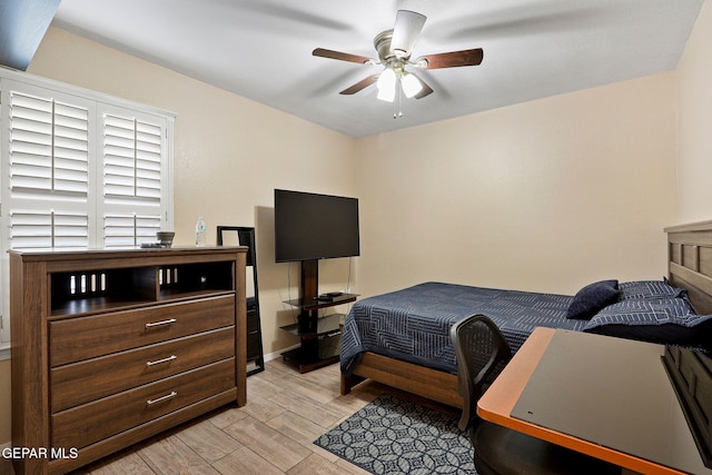 bedroom with light wood-style floors and a ceiling fan