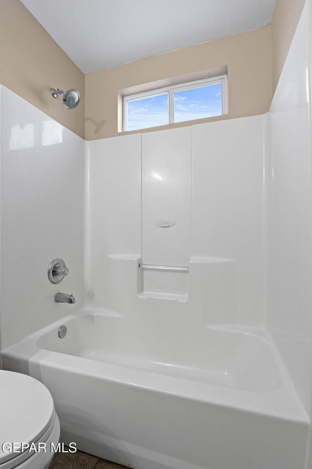 full bathroom featuring shower / washtub combination, plenty of natural light, and toilet