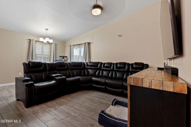 living area with lofted ceiling, wood finish floors, and a chandelier