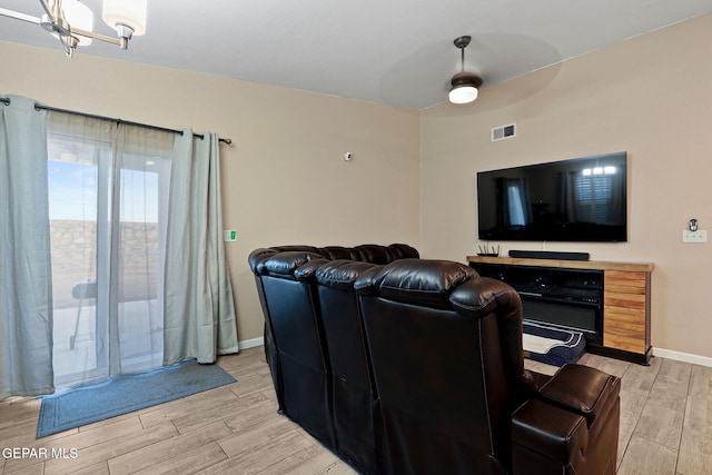 living area with wood tiled floor, visible vents, ceiling fan, and baseboards