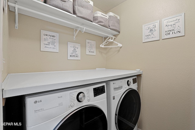 washroom with laundry area and washer and clothes dryer