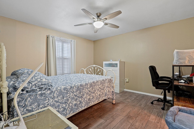 bedroom with ceiling fan, baseboards, and wood finished floors