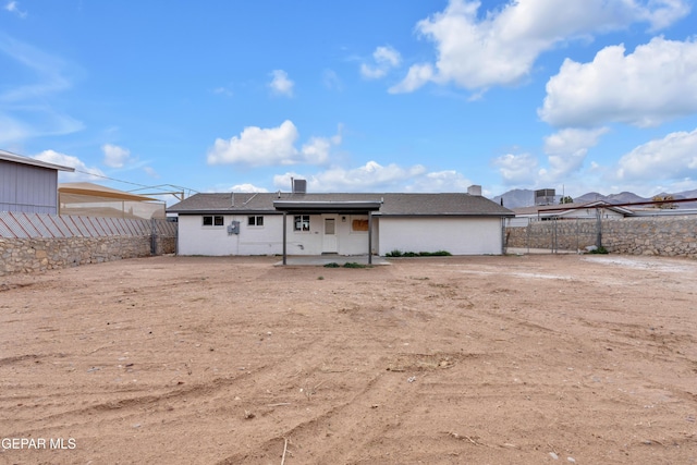 back of property with a patio area and a fenced backyard