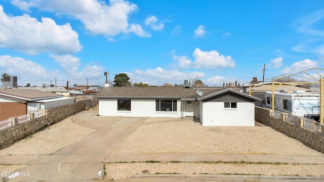 view of front of property with a patio and fence