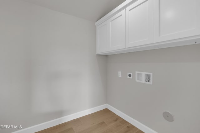 laundry room with washer hookup, cabinet space, light wood-style flooring, hookup for an electric dryer, and baseboards