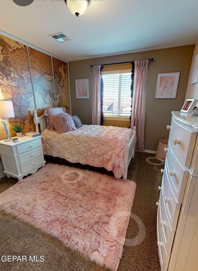 bedroom featuring baseboards and visible vents